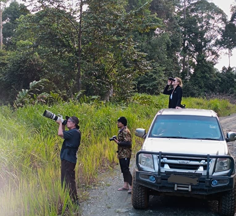 a man taking a picture of a truck with a camera