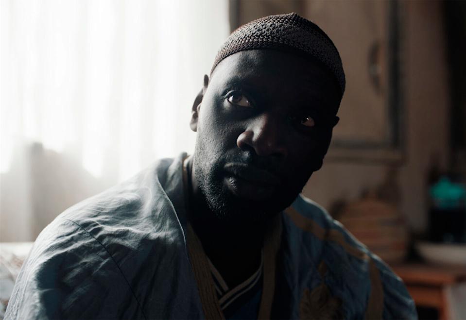 a man with a hat and a blue shirt