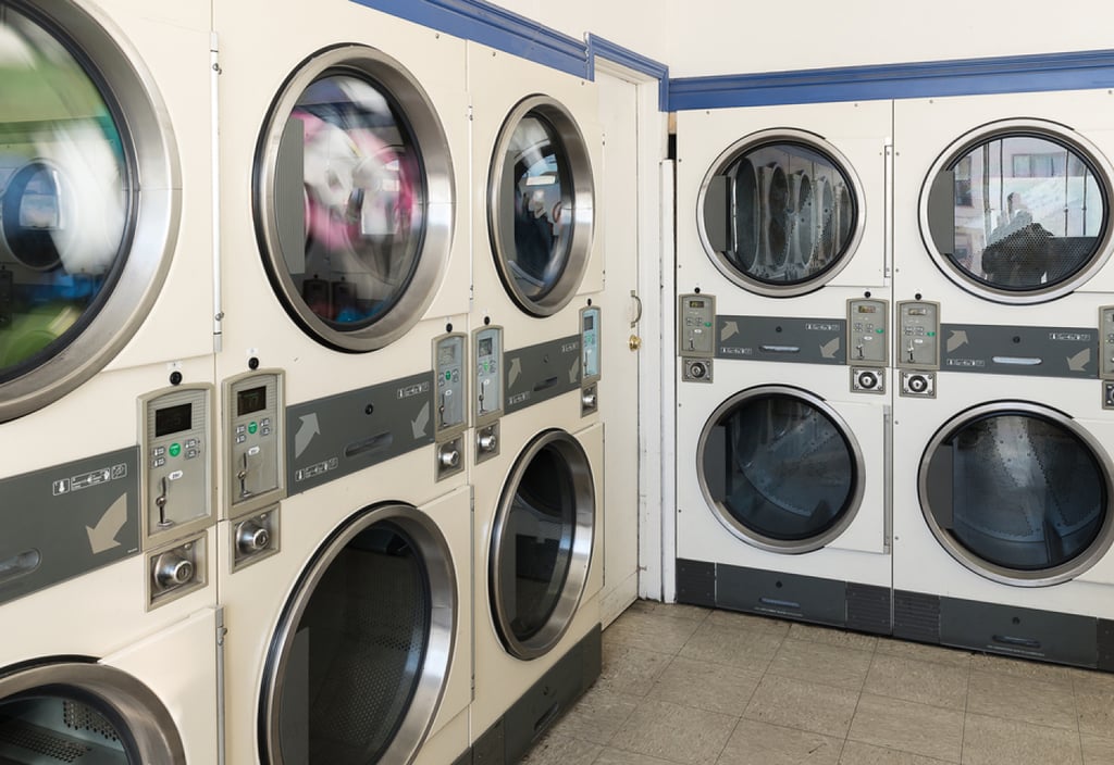 commercial laundry room with coin operated washers and dryers