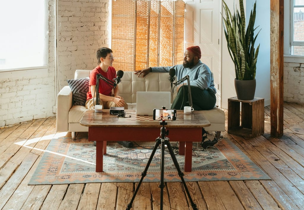 Video podcaster and guest sitting on a sofa