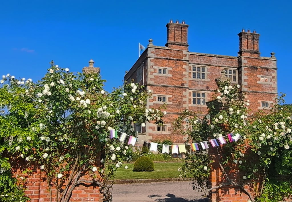 Soulton Hall, Shropshire. LGBTQ Pride bunting hangs in the foreground.