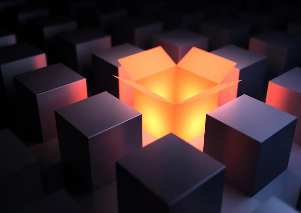 A glowing open box is surrounded by closed grey boxes.