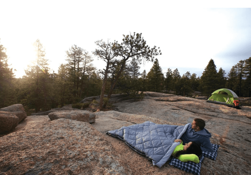 Couple cozy camping in Coleman Tandem double sleeping bag, best double sleeping bag for couples