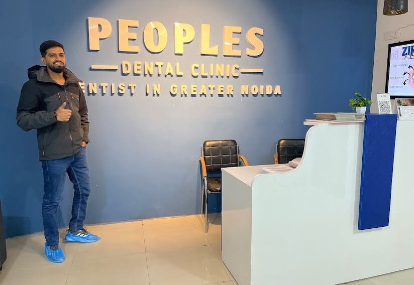 A dental patient at Peoples Dental Clinic showing a Thumbs up and recommending the dentist in greater noida
