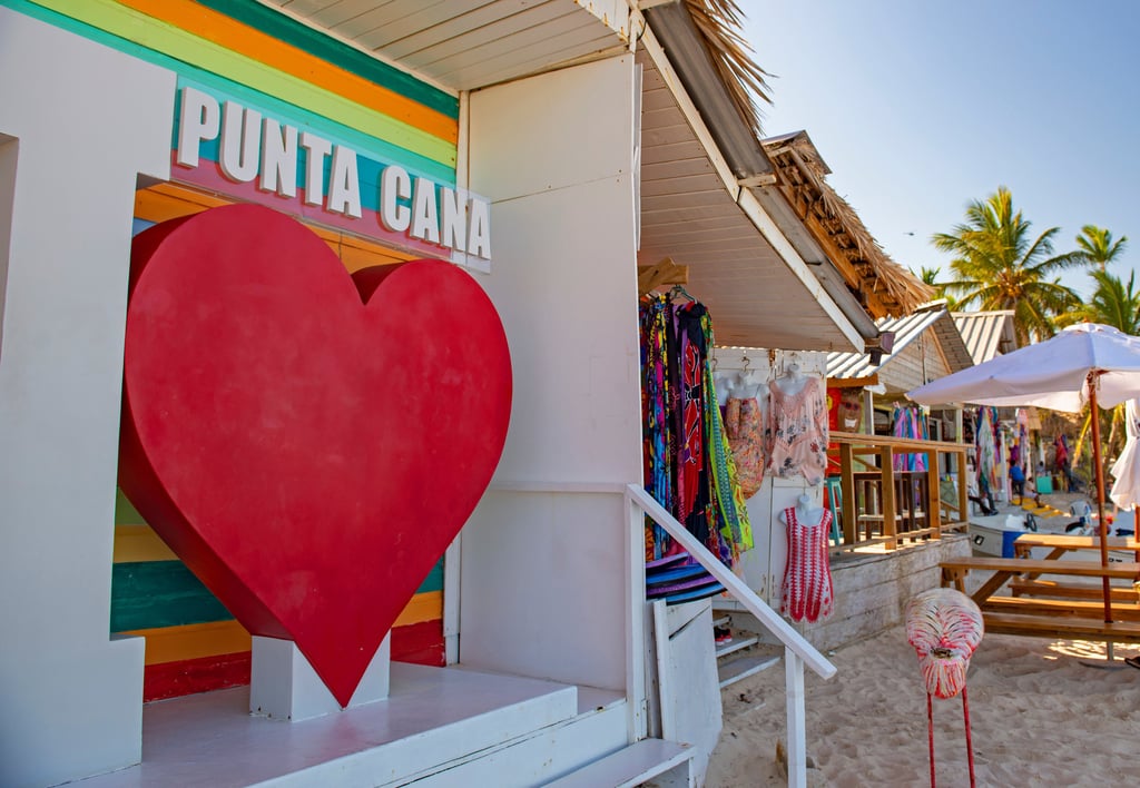 Colorful Punta Cana beach market with "I ❤️ Punta Cana" sign and tropical souvenirs