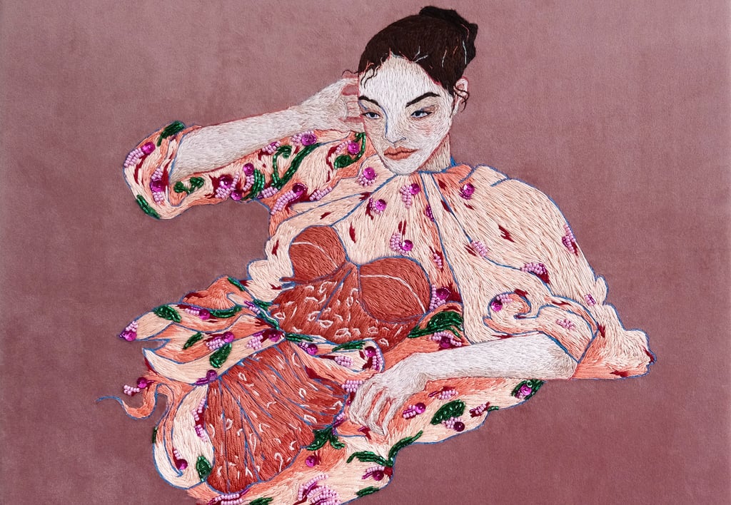 an embroidery of a woman in a pink dress and floral kimono sitting