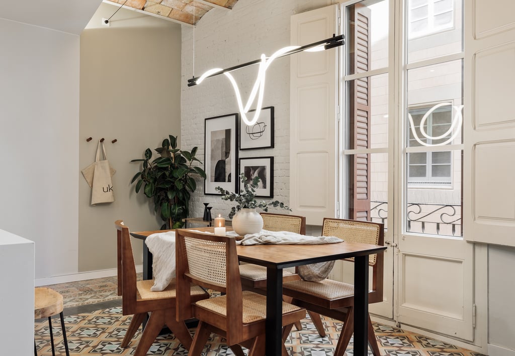 Modern dining room with exposed brick walls, tile floors and Catalan vaulted ceiling interior design