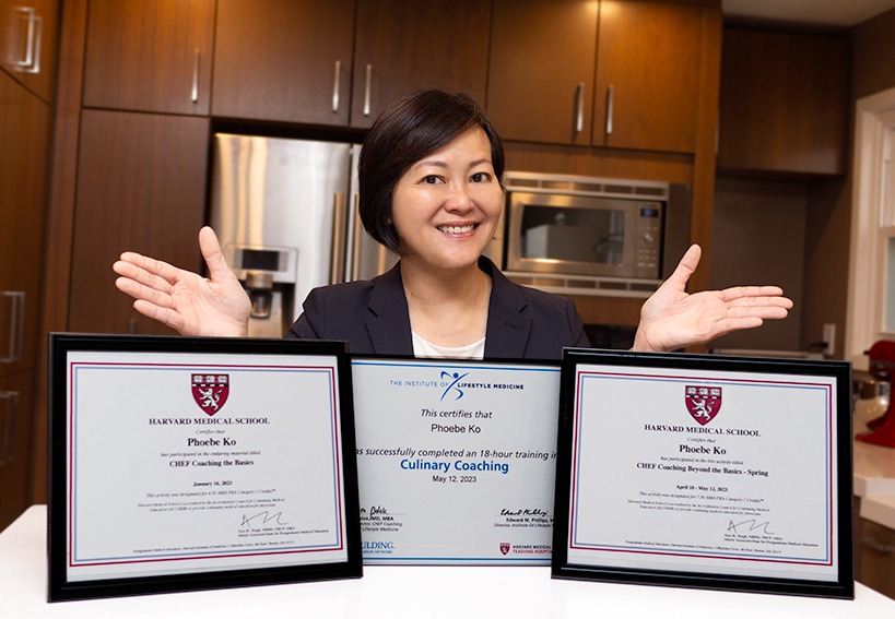 A woman confidently showing three framed certificates with her hands