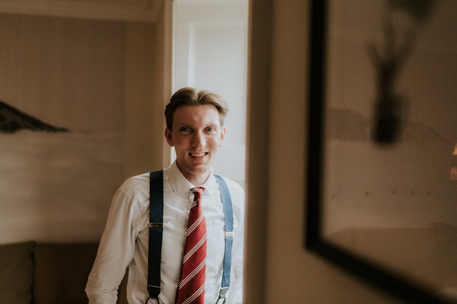 a man in a white shirt and suspender tie tie