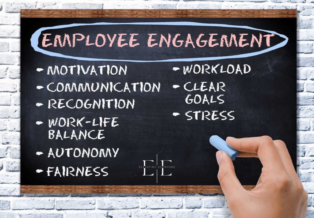 a person writing employee engagement on a chalkboard