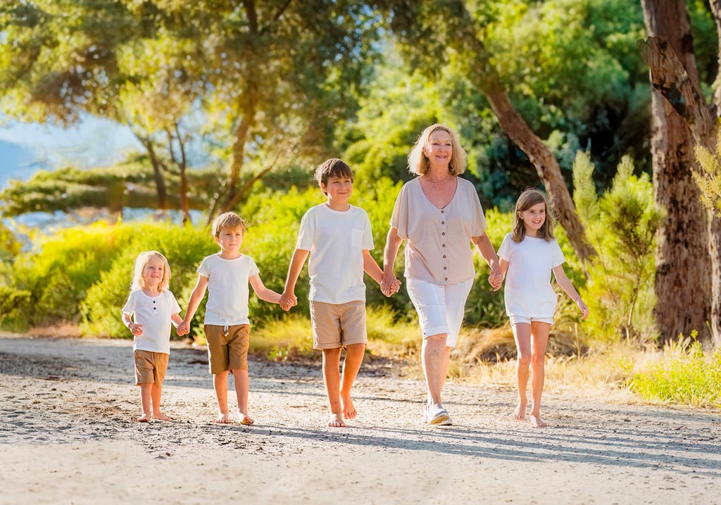 Grandmother walking with four grandchildren along a sunny park path, Perth family photographer Fisher Photography