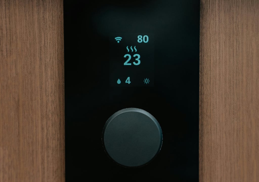 Smart digital thermostat with a black display and dial mounted on a wood wall for home climate control.