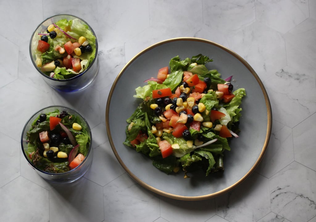a salad with fresh romaine, red leaf lettuce, bicolor corn and blueberries