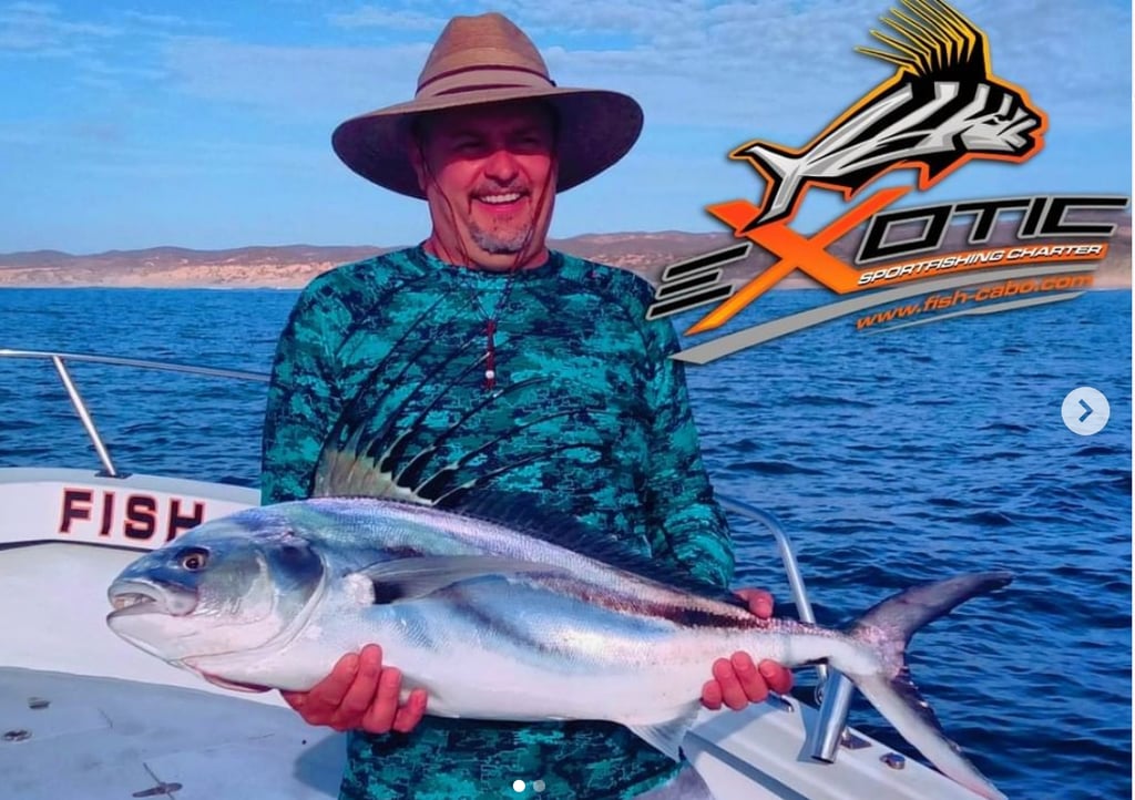 a man in a hat and a hat holding a fish
