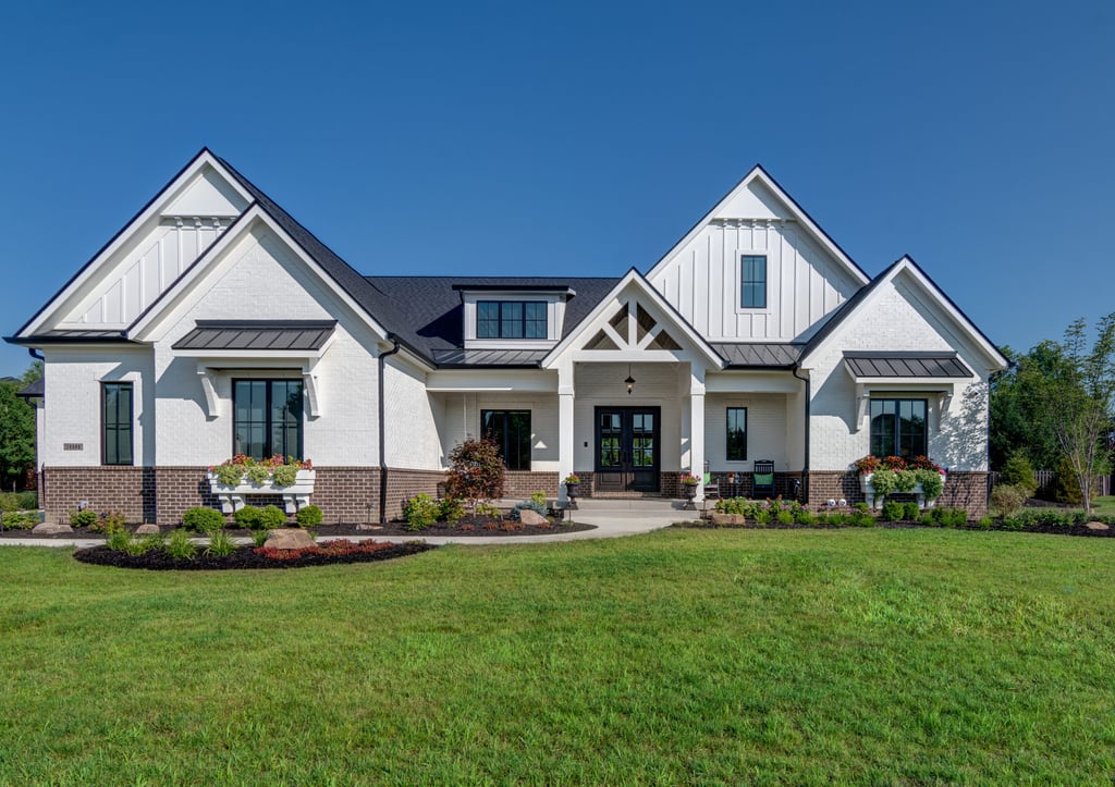White farmhouse-style custom home with gabled roof in Kane County, by Built to Last Custom Homes