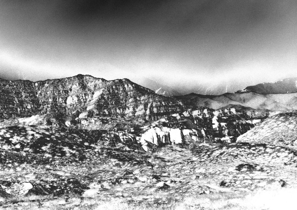 a black and white photo of a mountain range
