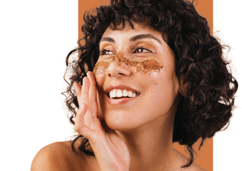 woman smiling using cafine all natural face scrub