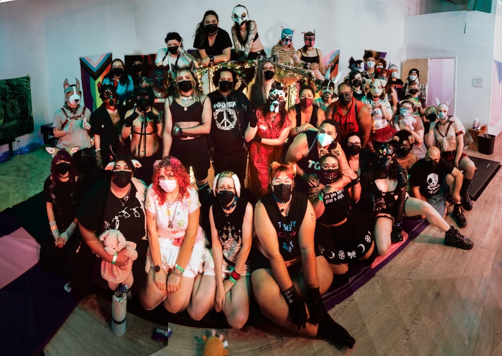 Human pet and animal players posing for a group photo in masks.