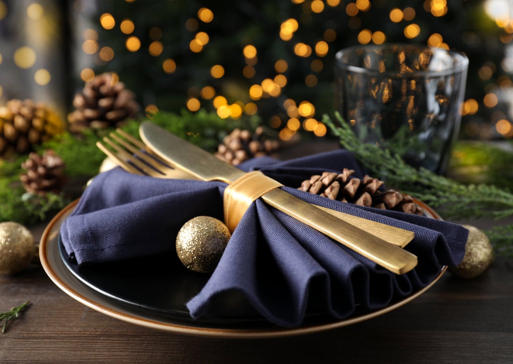 a plate with a gold fork and knife on it