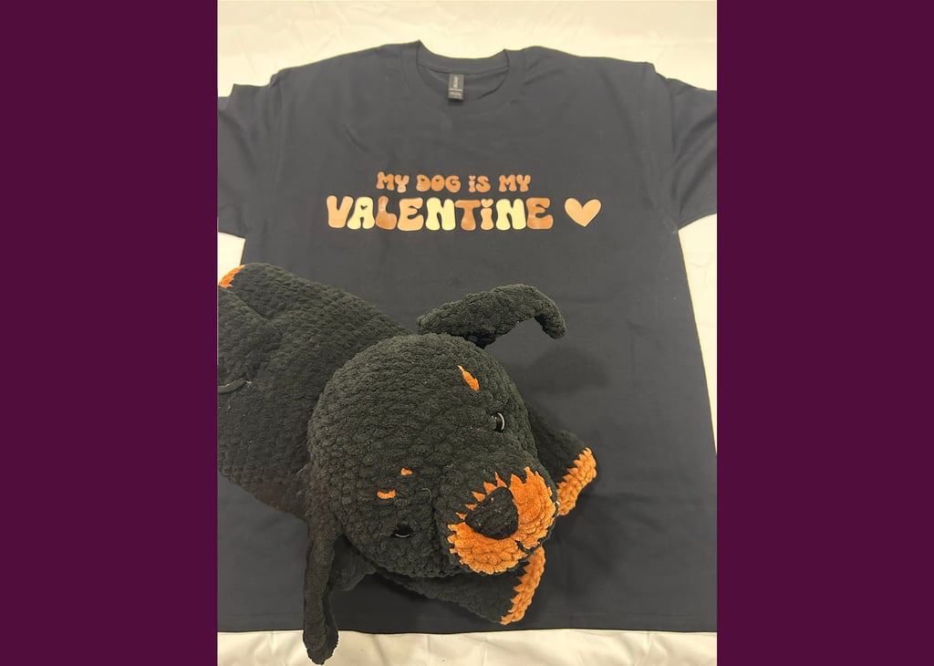 a tshirt that says "my dog is my valentine" with a stuffed rottweiler on top of it
