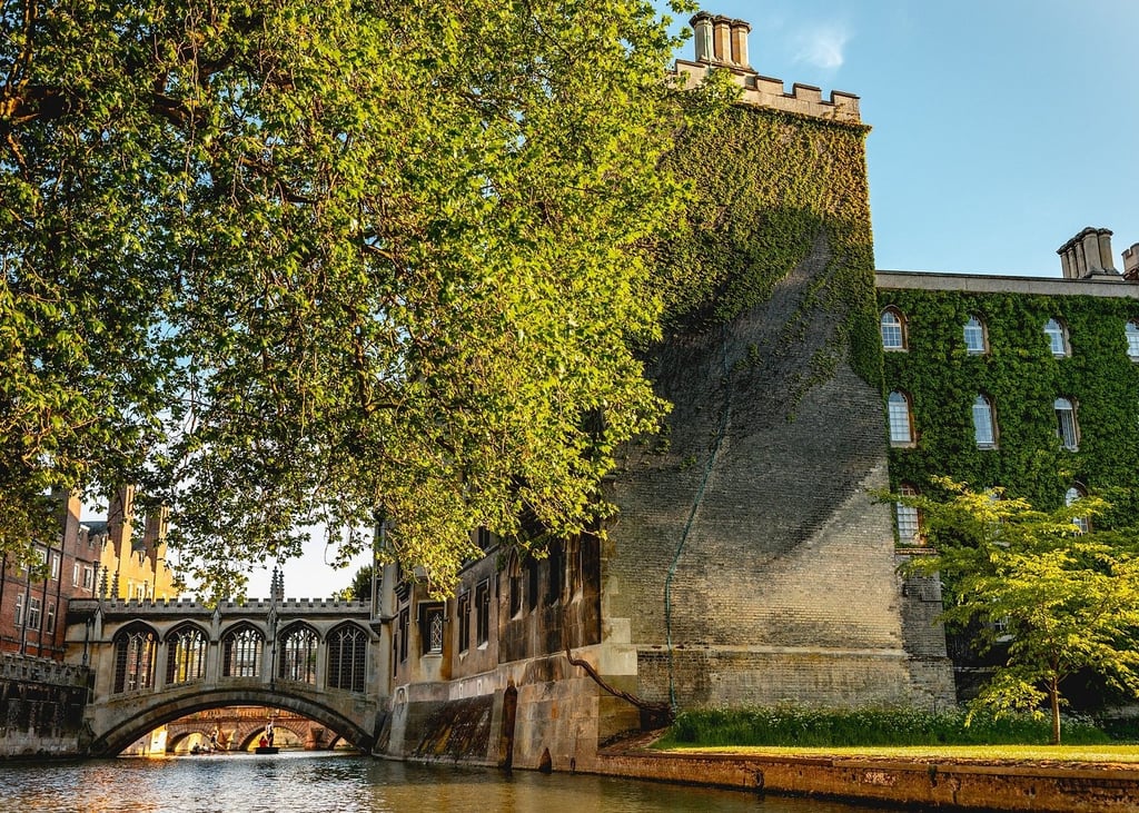 The Bridge of Sighs at St John's College, Cambridge, beside the River Cam with ivy-covered stone walls.