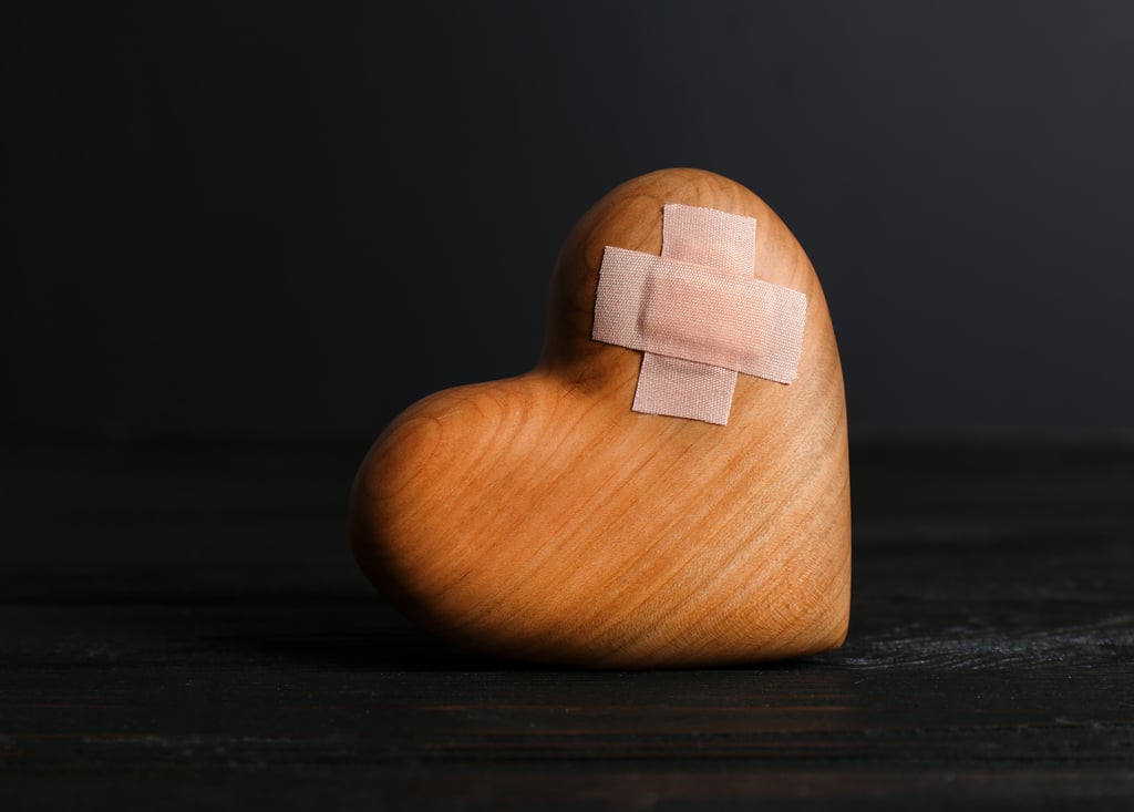 Wooden heart with a bandaid