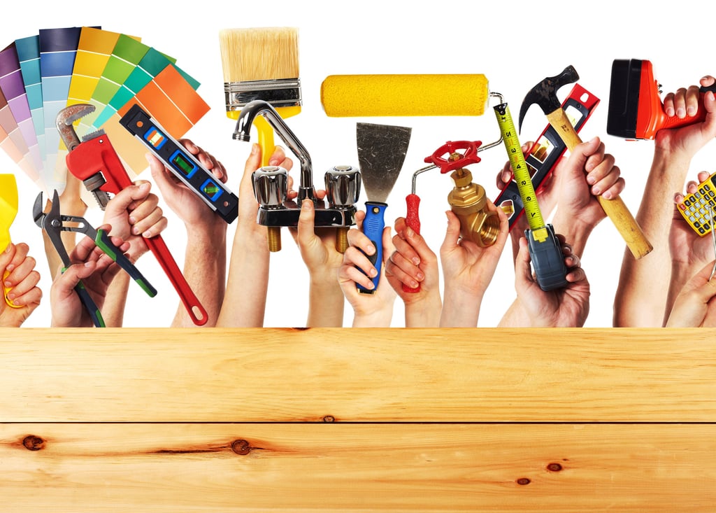 handyman holding up paint brush facuet electrical outlet spackle knife