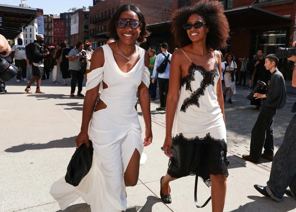 Street style at NYFW SS26: guests in chic white and black dresses with cut-out and lace details.
