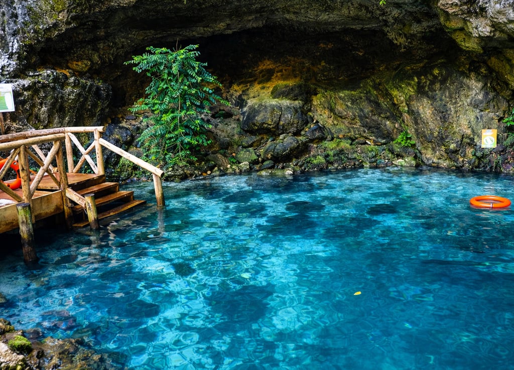Hoyo Azul cenote with crystal blue water at Scape Park Punta Cana Dominican Republic