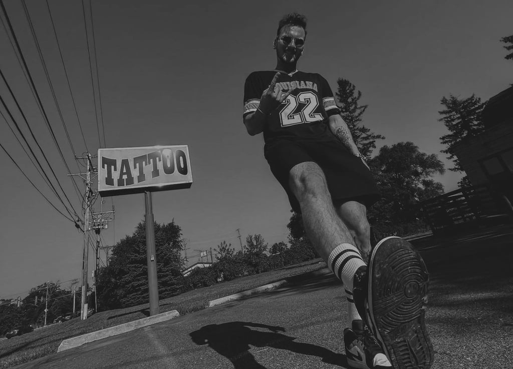 Jaris Ink next to tattoo sign