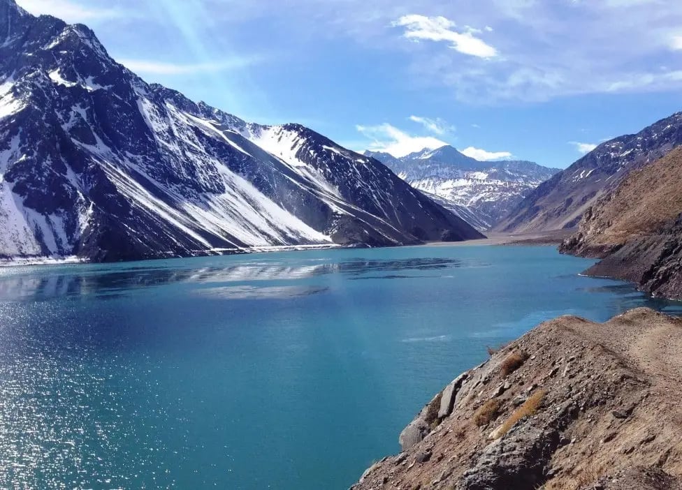 a mountain scene with a lake and mountains in the background