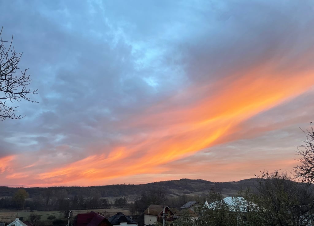 a sunset sky with a pink sky and a few clouds