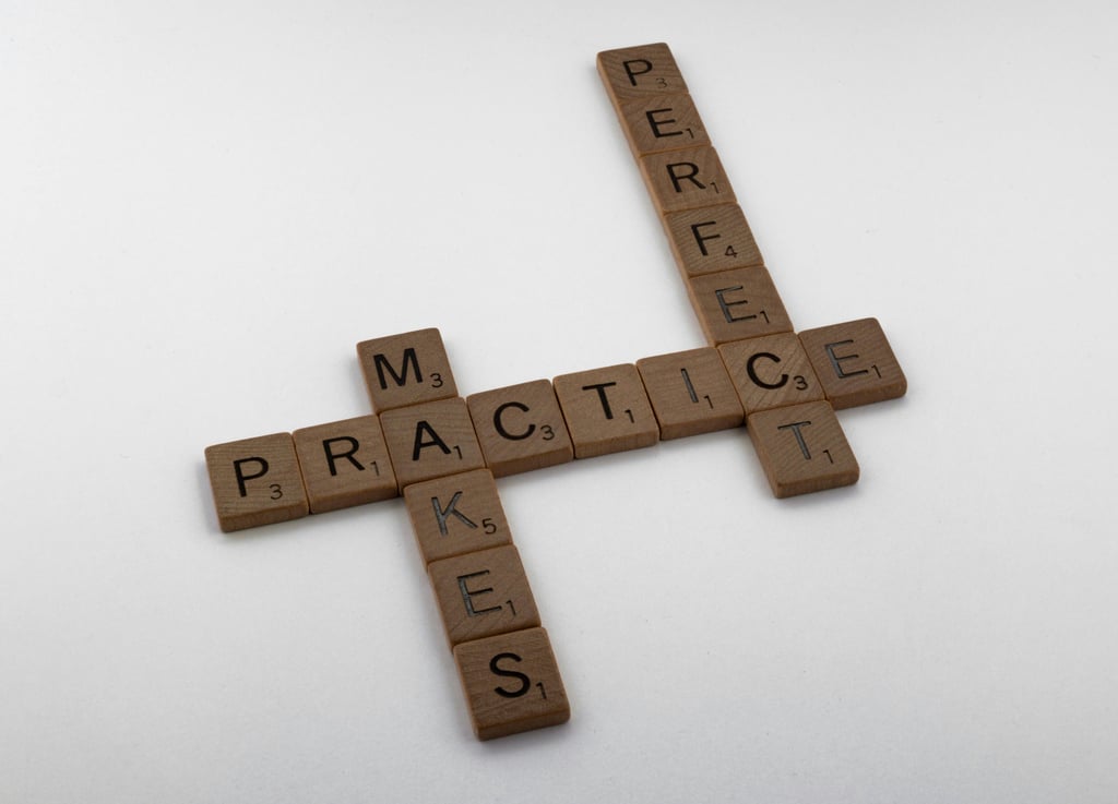Wooden letter tiles arranged to spell Practice Makes Perfect on a white surface.