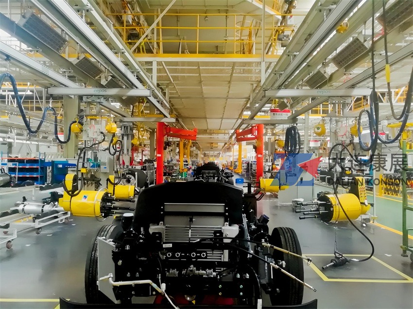 Four robotic five-axis wheel nut runners installing tires on a vehicle