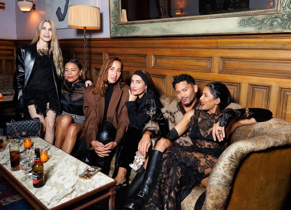 Guests in chic black and brown outfits at a New York Fashion Week party.