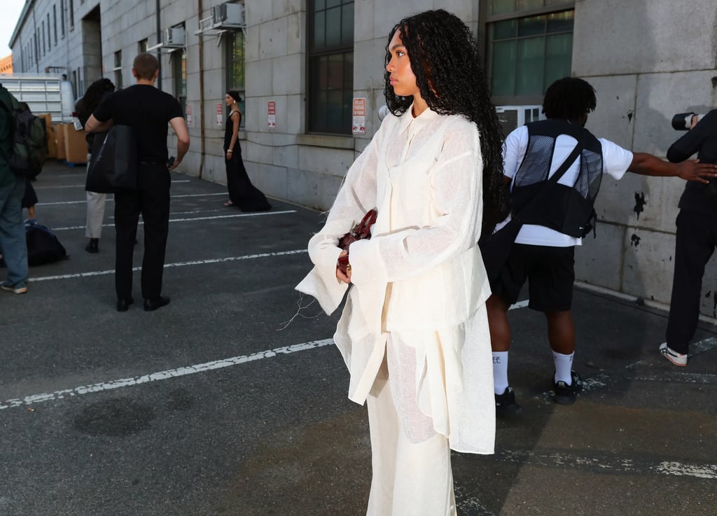 Street style at NYFW 2025 with guest in layered white suit.