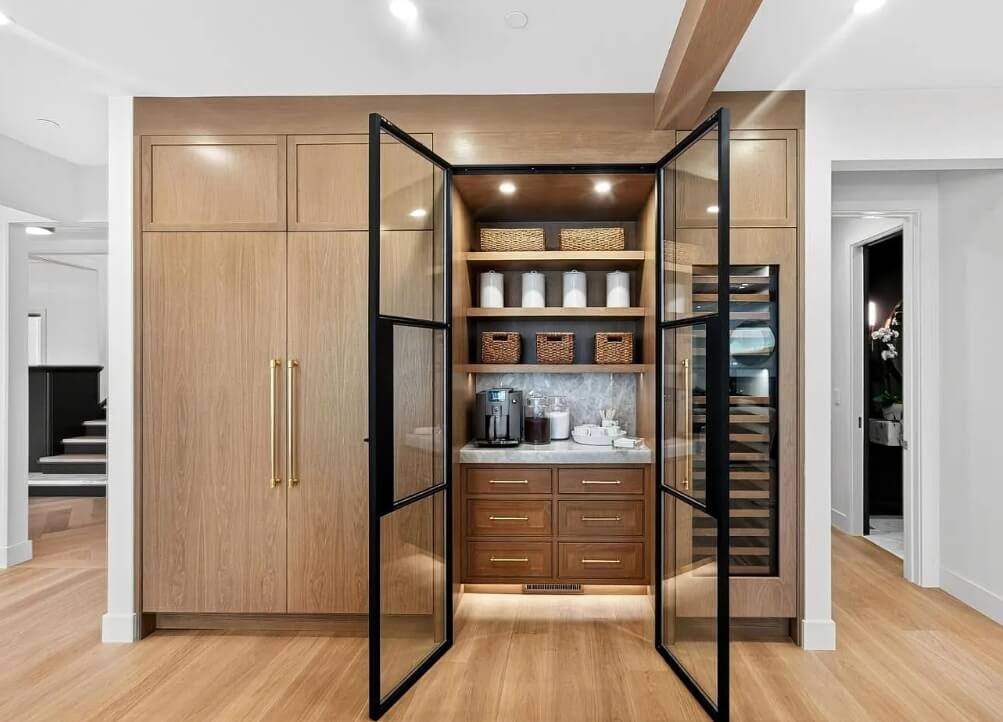 Built-in cabinet with open shelving, storage drawers, and glass doors in a home interior.
