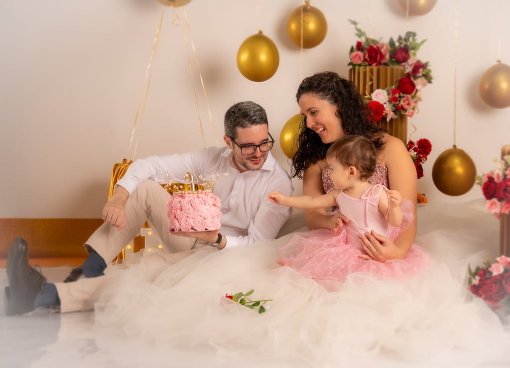 a man and woman sitting on a bed with a cake