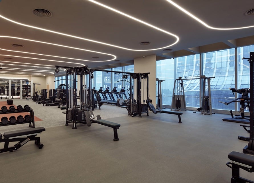 a gym with a lot of equipment and a bench