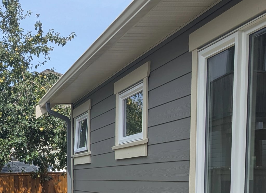 Side of house with crisp paint lines and new window trim