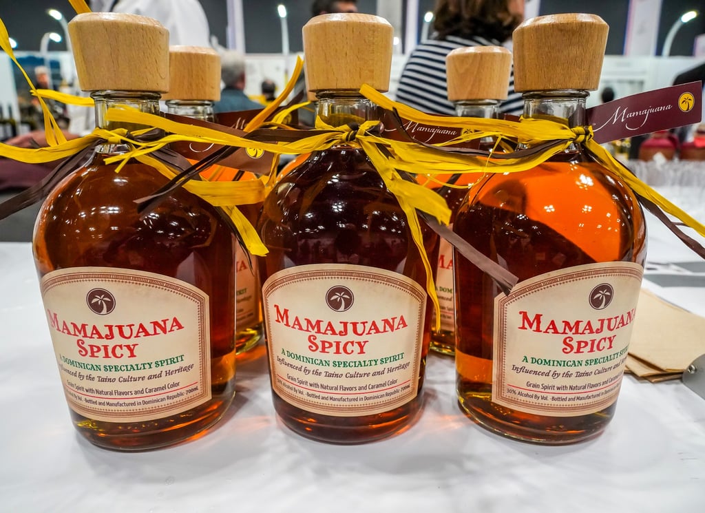 Bottles of Dominican Mamajuana Spicy on display at local market or festival
