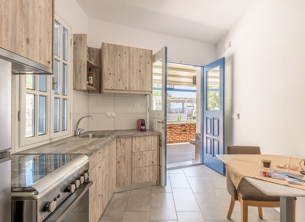 a kitchen with a table and chairs 