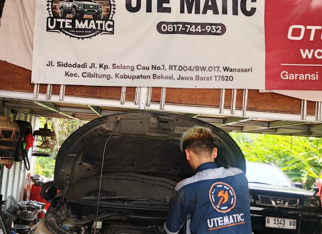 Mekanik sedang memeriksa transmisi mobil matic yang mengalami hentakan atau jedug