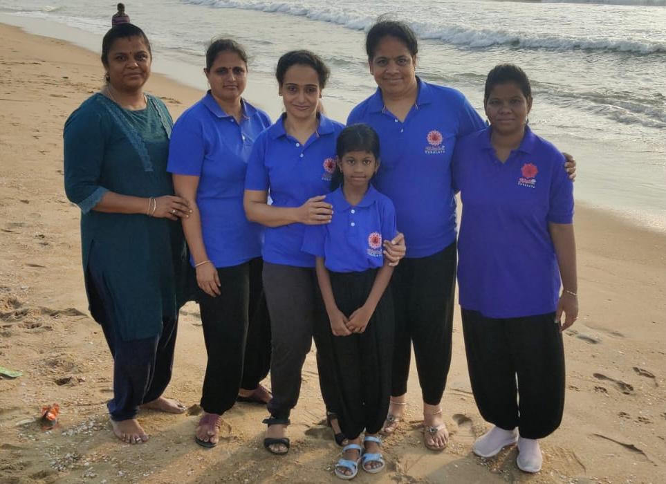 a group of people standing on a beach