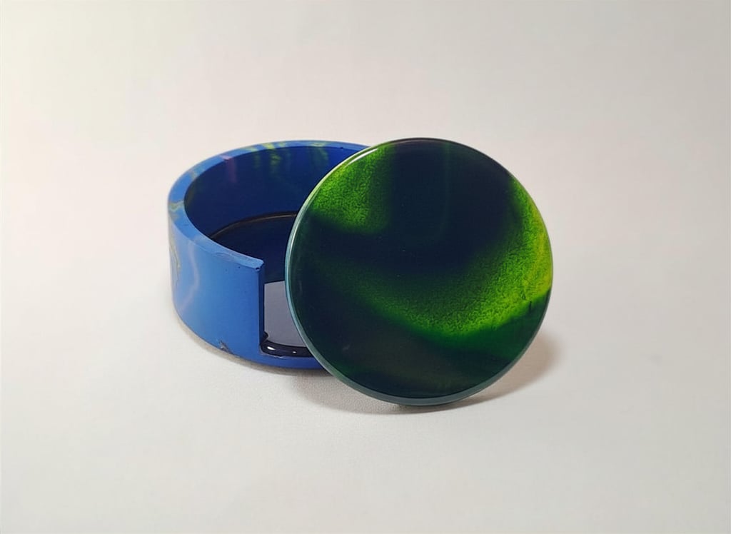Handmade green and blue swirl resin coaster set with matching holder with northern lights design.