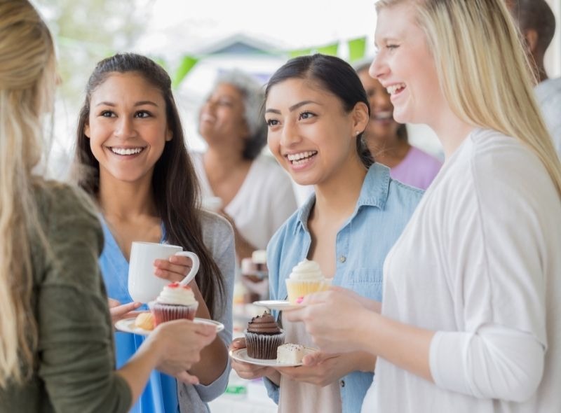 Apartment residents enjoying a community event, representing strong resident retention and engagement.