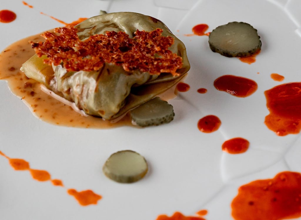 a plate with a small piece of food on it