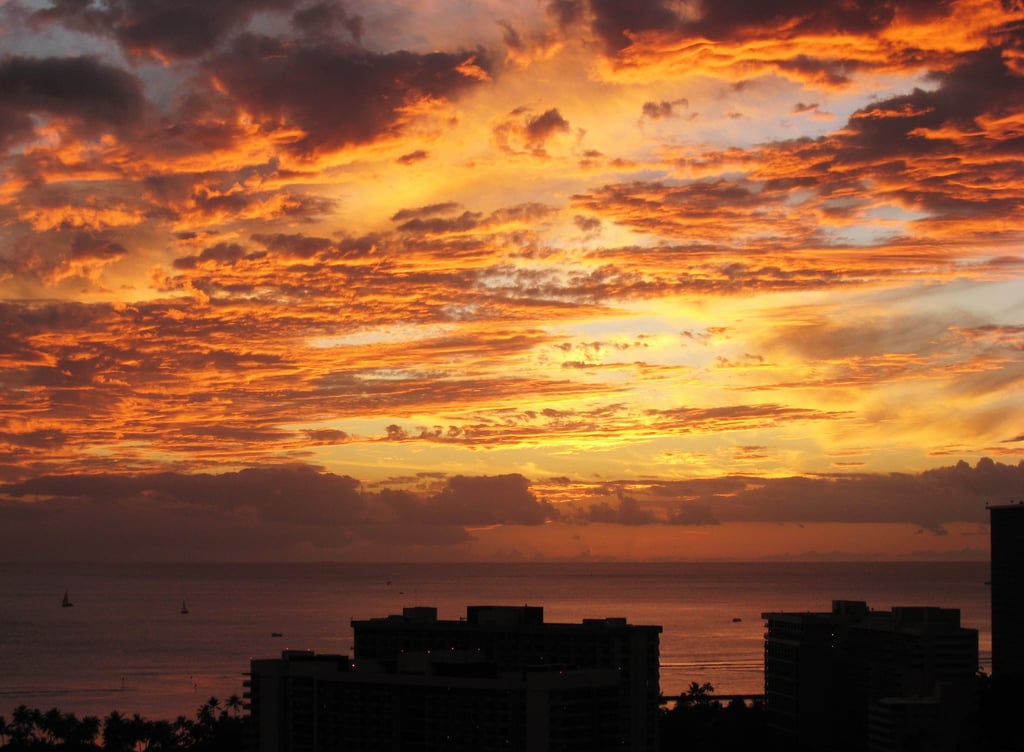 Photo of golden sunset with clouds in Waikiki