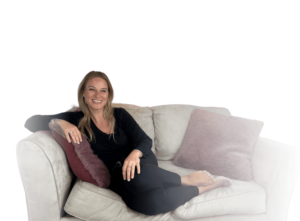 Patricia Vasylchuk, writer, editor, and founder of KingdomCOMM lounges a cream-coloured sofa
