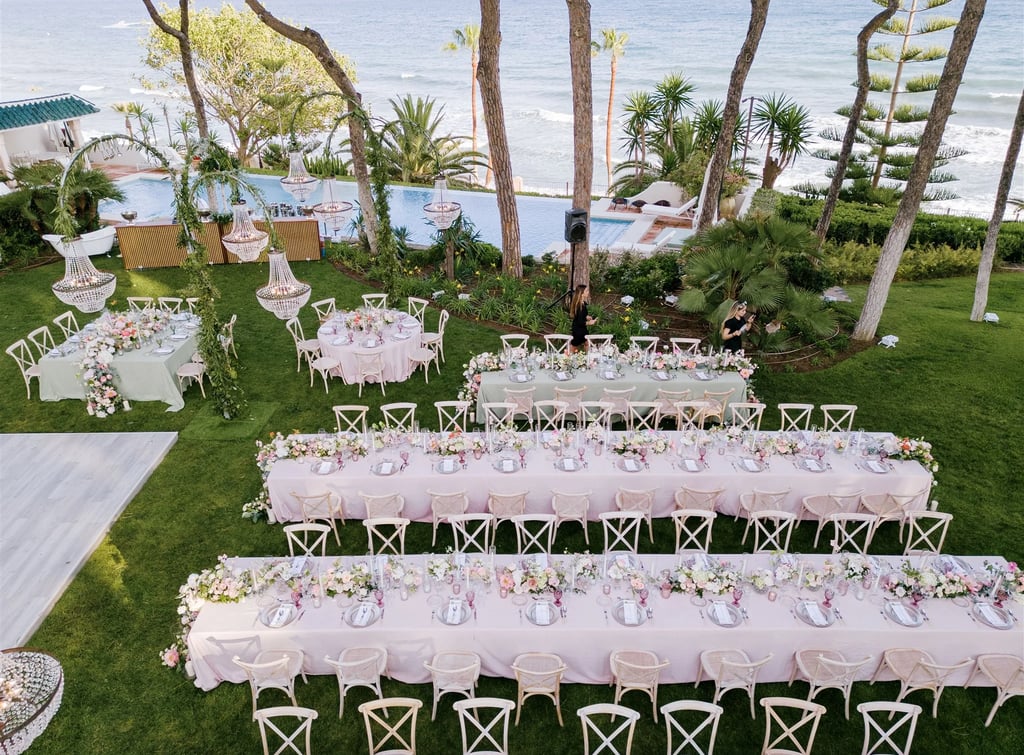 Seafront wedding dinner setup beside infinity pool